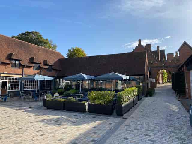 Charming outdoor venue at Coach House Kitchen, ideal for events with stylish canopies.