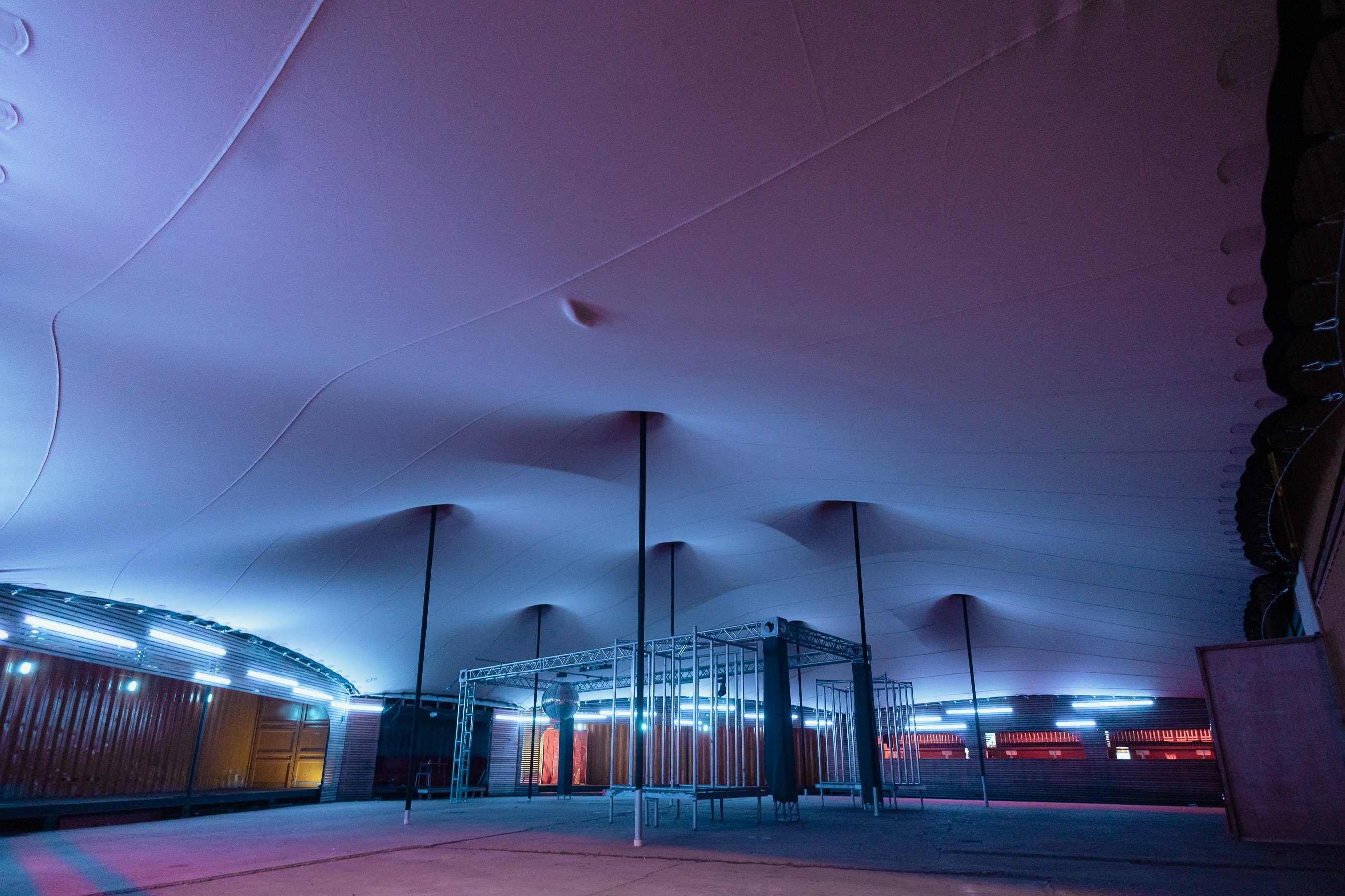 Modern event space with unique ceiling design, perfect for corporate meetings and social gatherings. - Banner