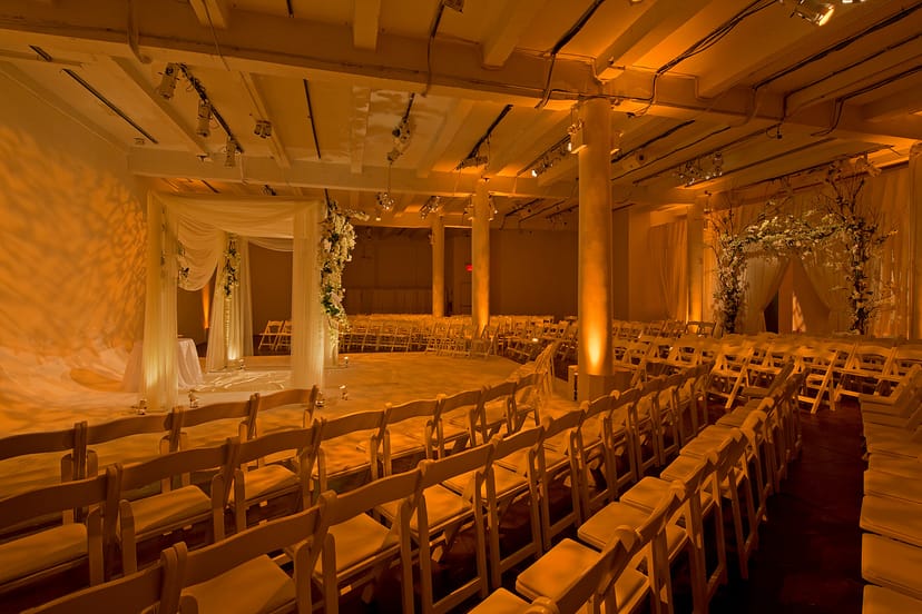 Elegant wedding venue with warm lighting and floral accents at Hudson Mercantile.