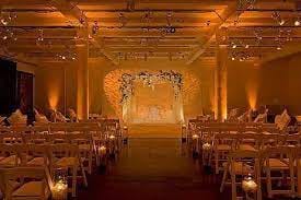 Elegant wedding venue with floral backdrop and warm lighting at Hudson Mercantile.