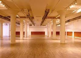 Spacious event venue with polished floors and natural light at Clifton Mercantile.