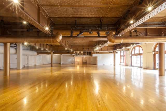 Spacious Altman Building venue with polished floors, ideal for weddings and conferences.