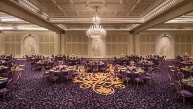 Elegant Gala Ballroom at Palazzo Versace Dubai with purple linens, perfect for upscale events.