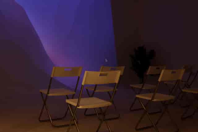 Minimalist meeting room with folding chairs for workshops and small gatherings.