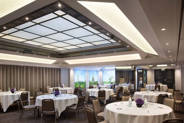 Elegant event space at Salon La Pagerie with purple floral centerpieces for weddings and meetings.