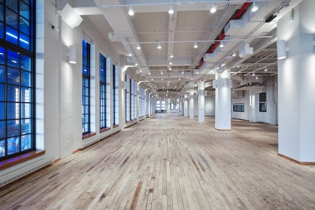 Spacious West Edge event venue with large windows, perfect for conferences and gatherings.