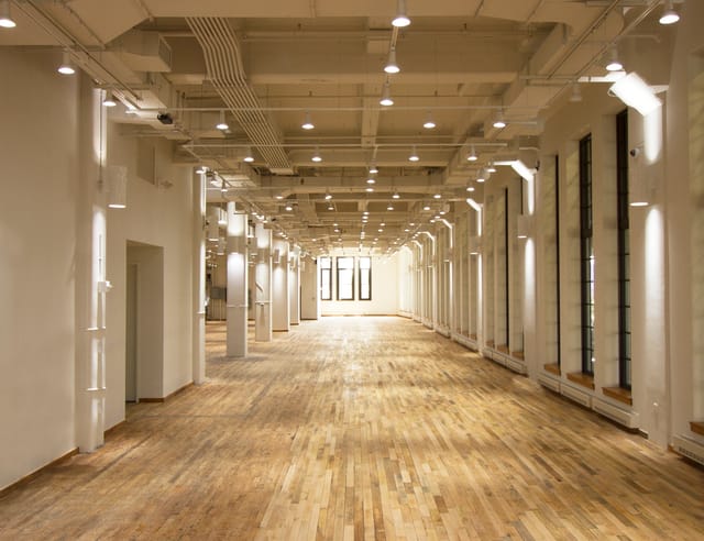 Spacious West Edge venue with polished floors, ideal for conferences and social events.