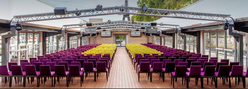 Modern event space at Les Salons Nework with Eiffel Tower backdrop, ideal for conferences.
