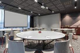 Modern meeting room with round tables for collaboration at Radisson RED, Rosebank.
