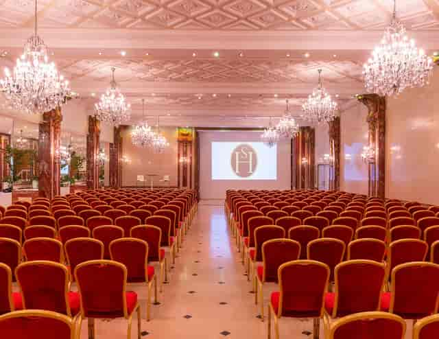 Elegant conference room with chandeliers, ideal for corporate events and presentations.