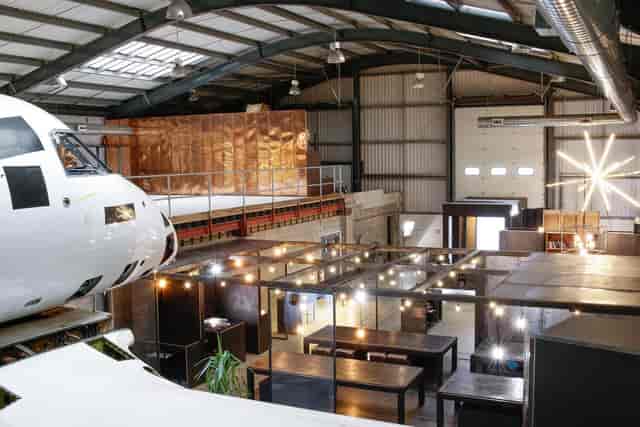 "Spyder Studios event space with airplane fuselage centerpiece for corporate and social events."
