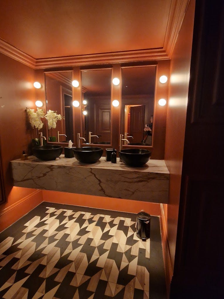 Luxurious BANKERS OFFICE restroom in Liverpool with marble countertops and elegant decor.