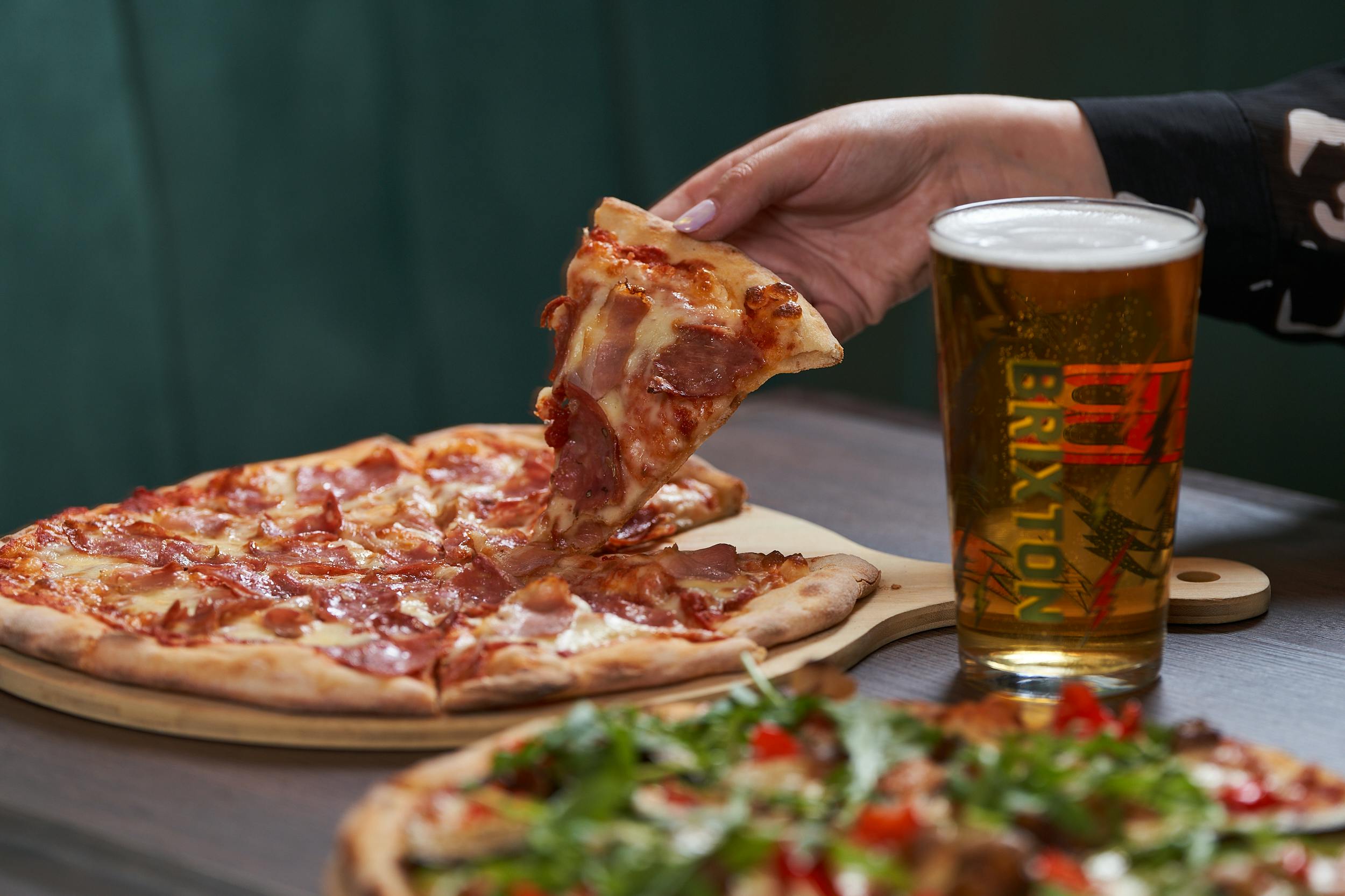 Delicious pizza and beer at SOUND Sports Bar for casual networking events.