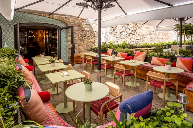 Vibrant outdoor event space with colorful seating at The Little Scarlet Door.