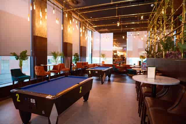 Stylish event space with pool tables at Newton's Bar, ideal for networking and gatherings.