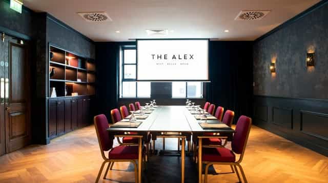Modern meeting room with long table, ideal for corporate events and presentations.