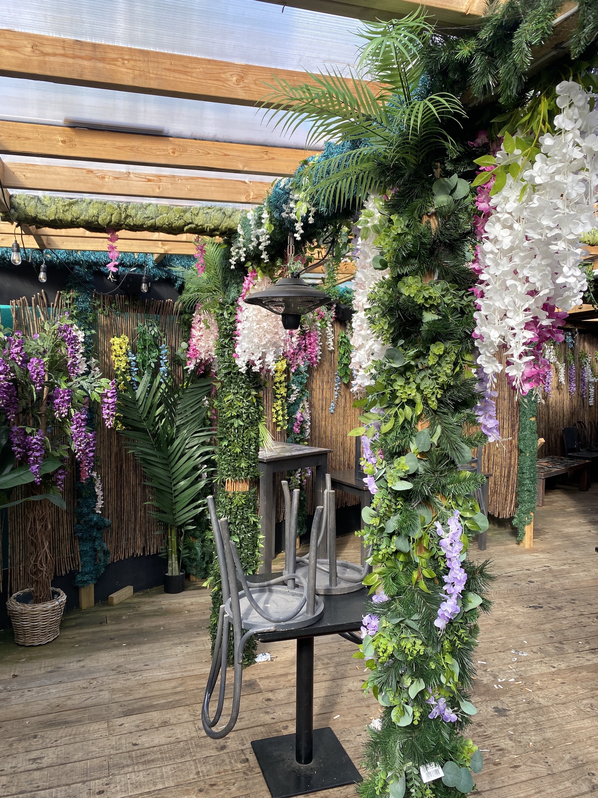 Vibrant event space with artificial flowers for tropical-themed gatherings. - Banner
