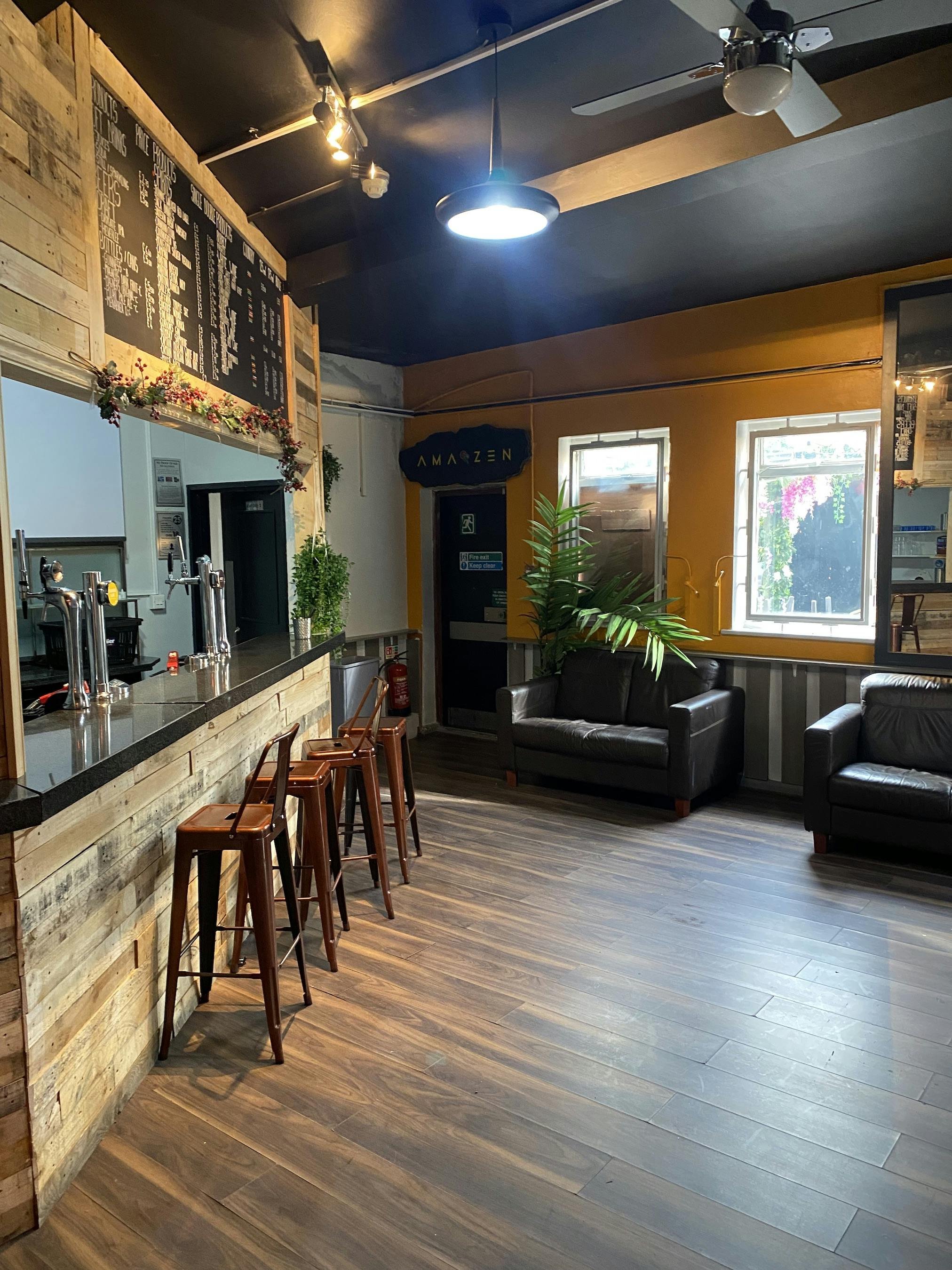 Cozy bar venue with warm lighting, perfect for gatherings and networking events.