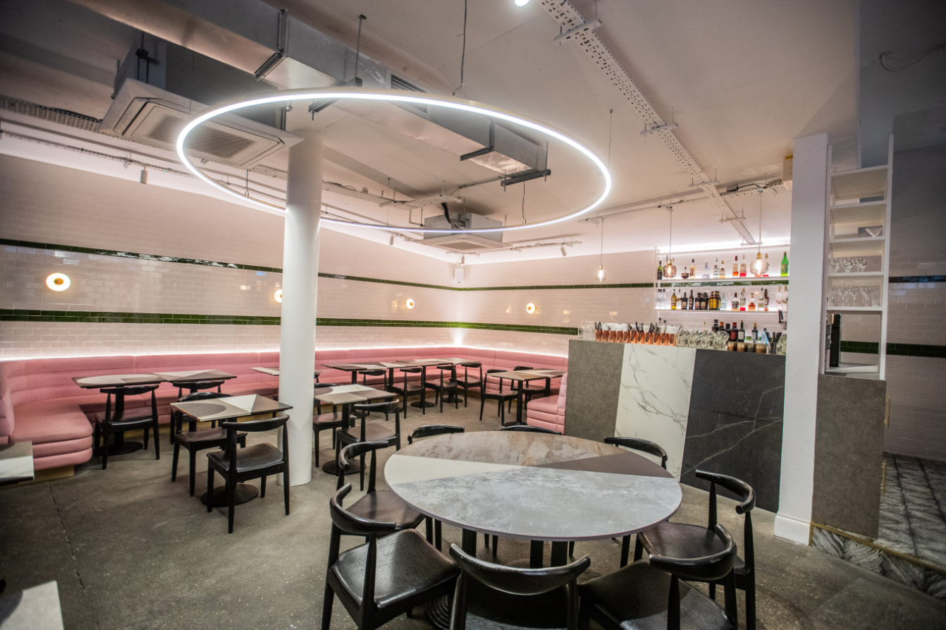 Modern lounge venue with circular lighting for intimate gatherings and cocktail events. - Banner