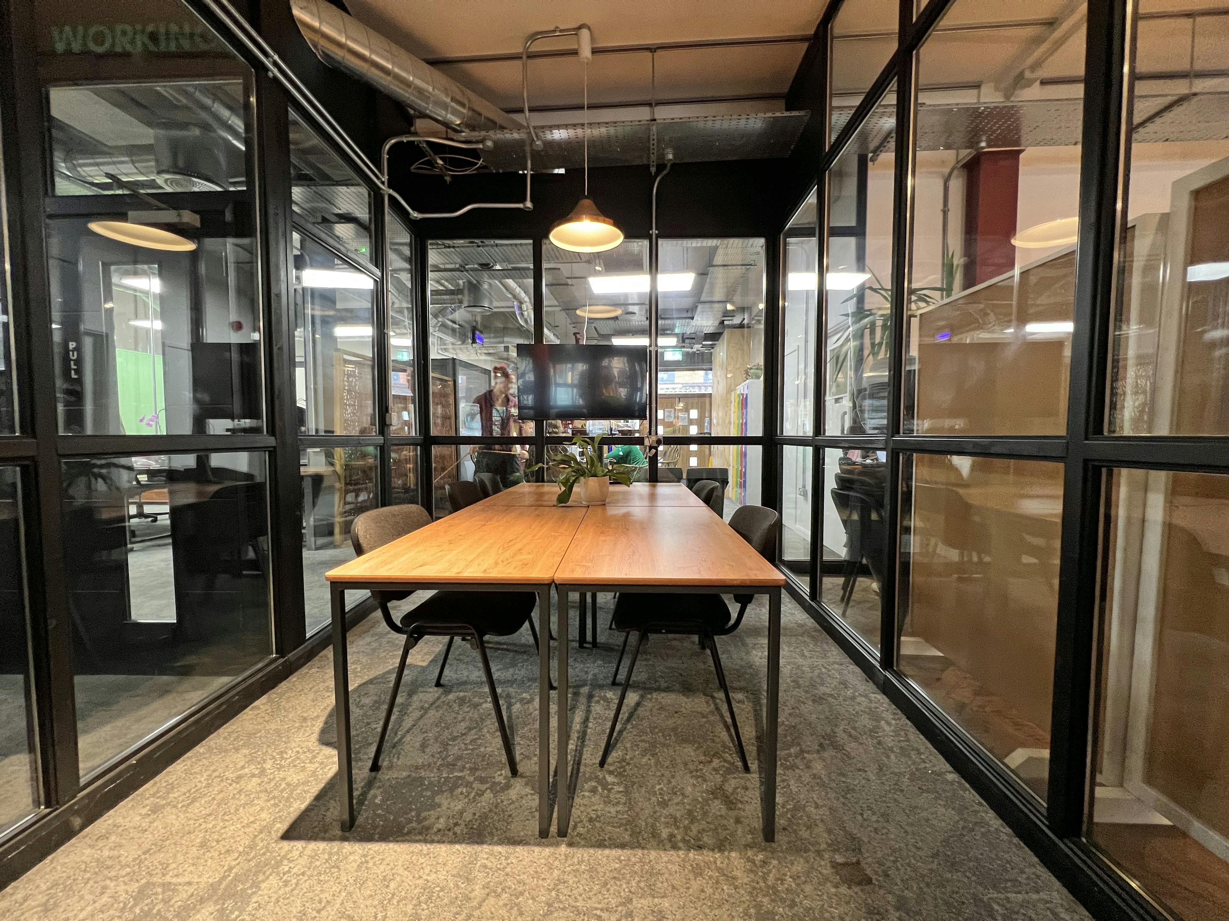 Modern Copper Meeting Room with wooden table, ideal for team meetings and brainstorming.