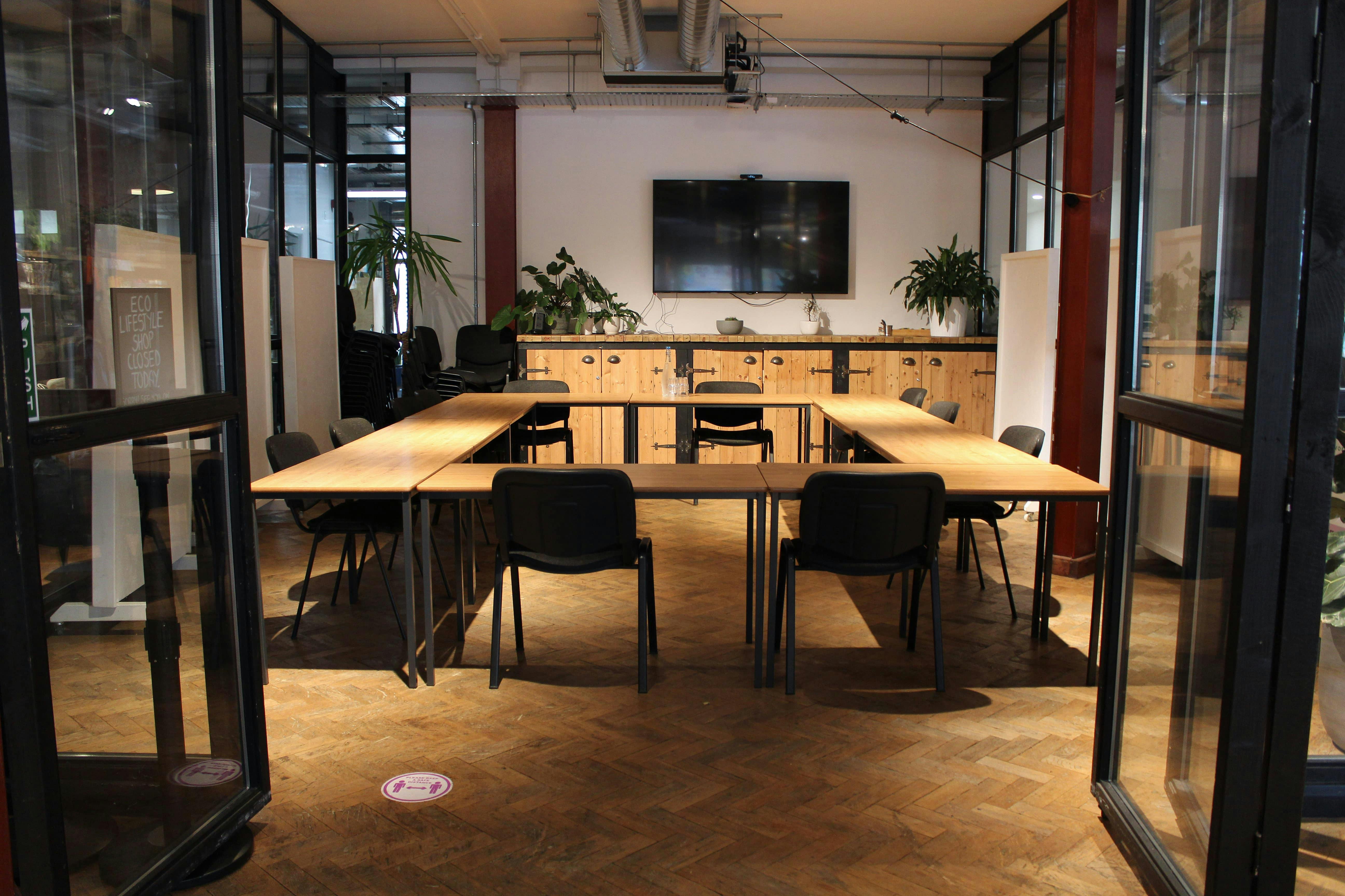 Modern Copper Meeting Room with wooden table, ideal for collaborative meetings and presentations.