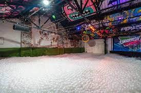 Vibrant event space with white balls and graffiti walls for creative gatherings in Birmingham.