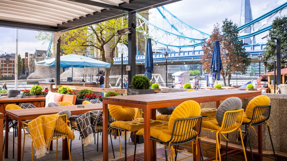 Vibrant outdoor event space at The Tower Hotel with stylish seating and Tower Bridge backdrop.