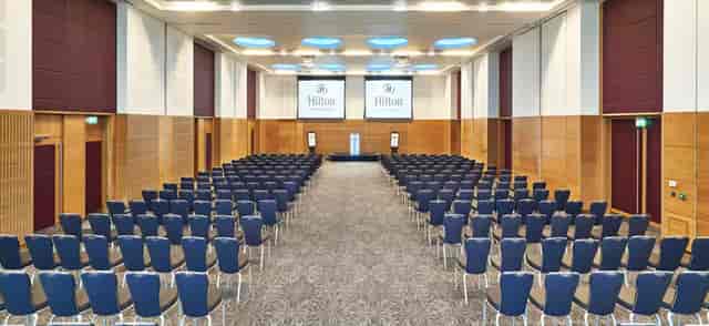 Sir Bobby Robson Ballroom conference setup with screens for corporate events, spacious and modern.