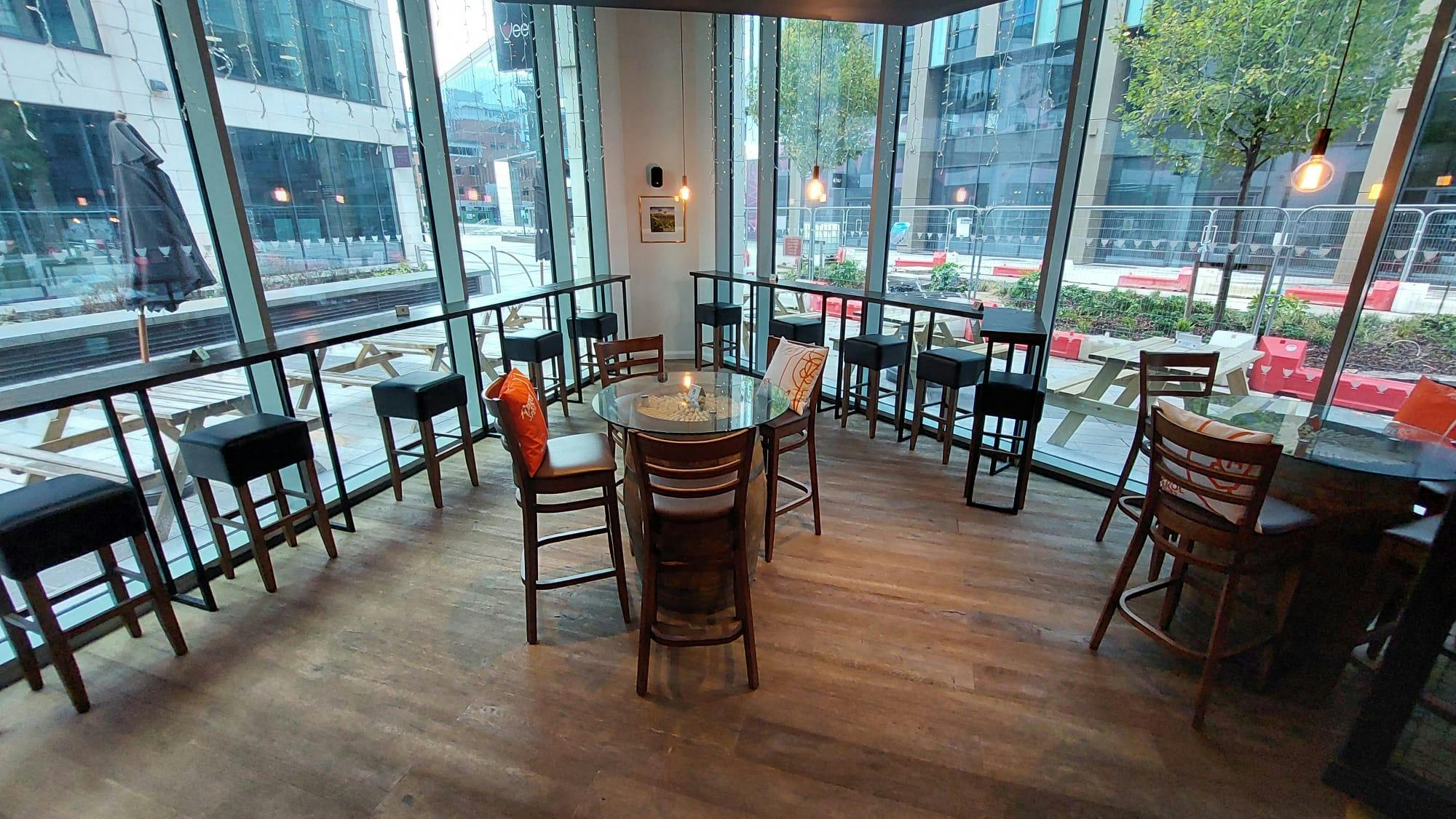 Semi-private meeting space with round table at Veeno Italian Wine Bar Leeds for networking events.