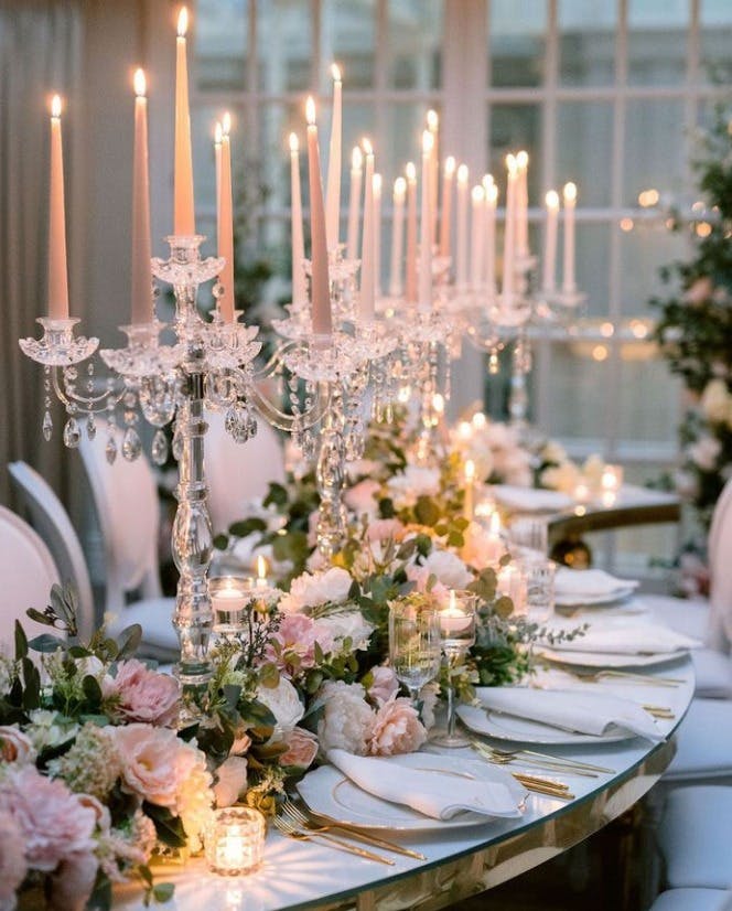 Elegant Tower Suite table with pink candles, perfect for weddings and upscale events.