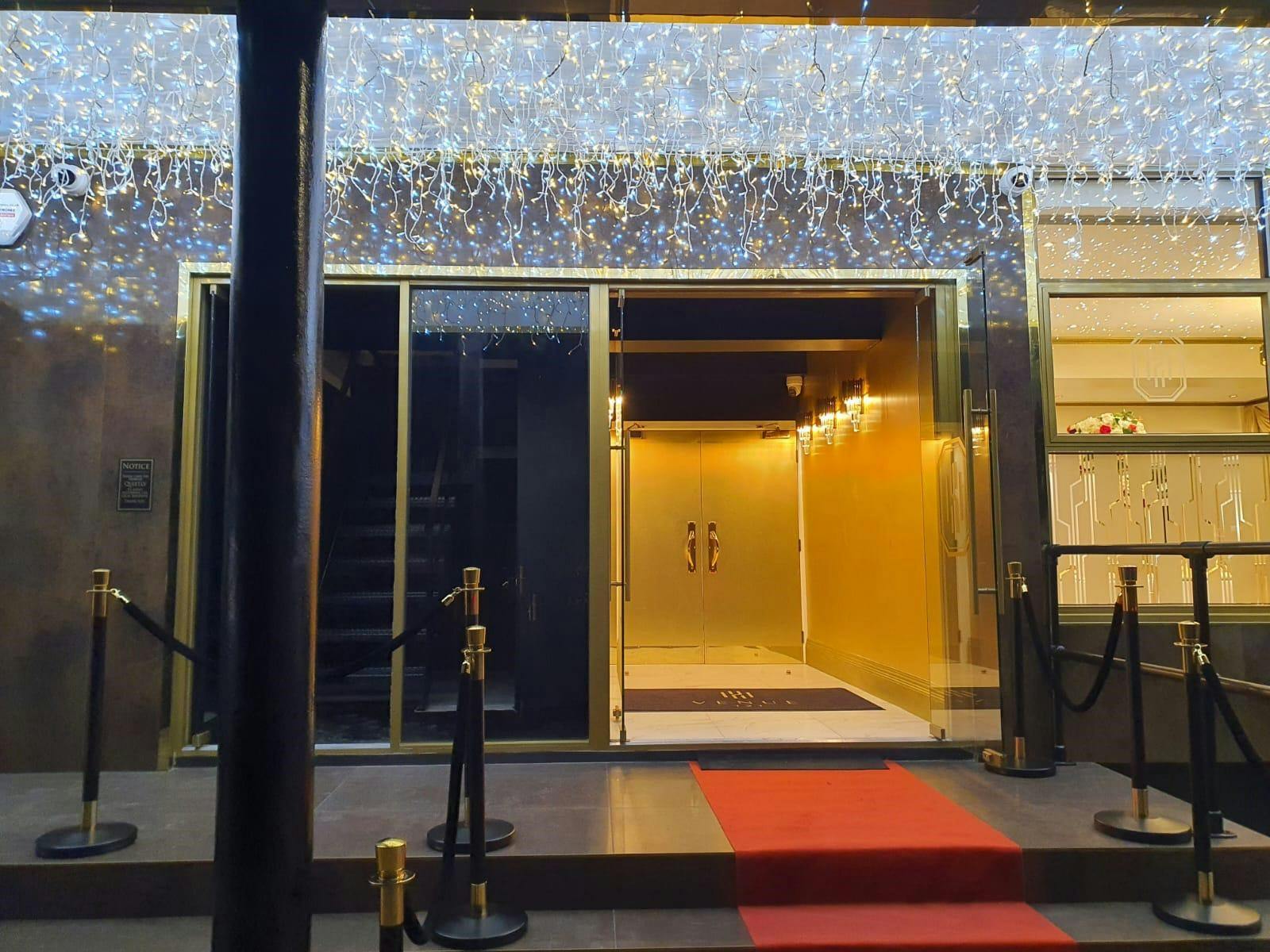 Elegant ballroom entrance with red carpet, perfect for upscale events and galas.