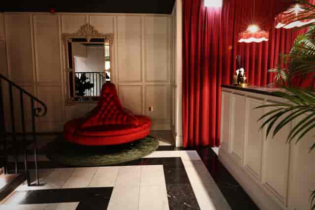 Stylish lobby at The Bar, featuring plush red seating for elegant events and gatherings.