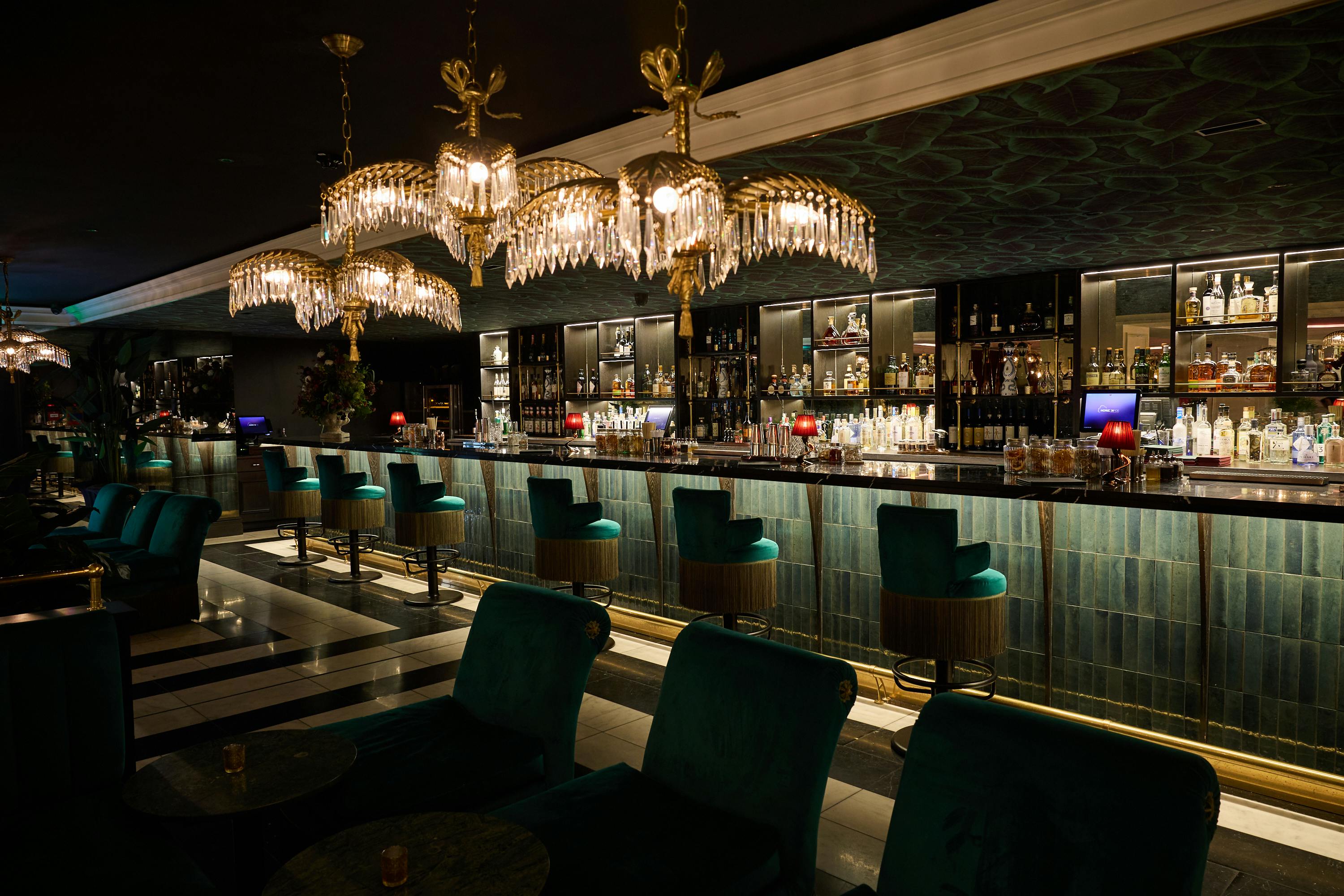 Sophisticated bar with elegant chandeliers for upscale events and networking.