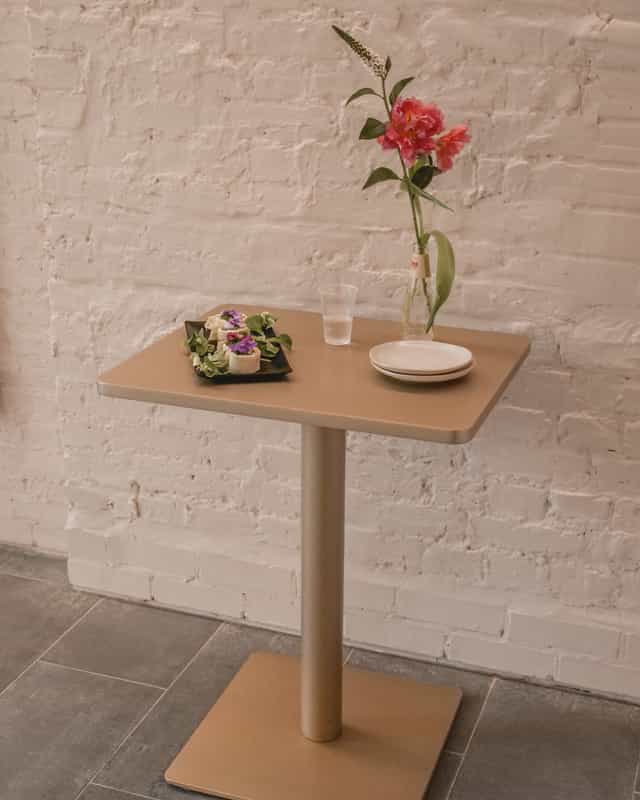 Minimalist event setup at Sunrise Studio with elegant table and floral arrangement.