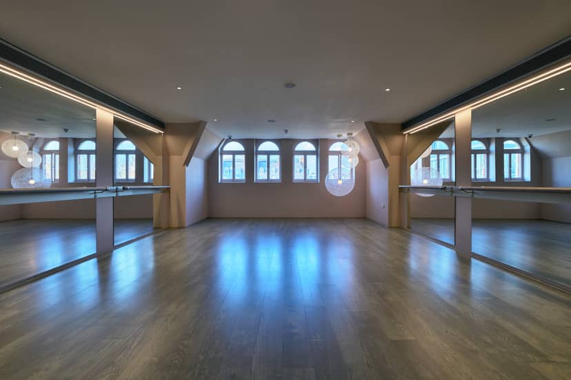 Light Loft at Vita Boutique Fitness, a bright event space with polished wood floors.