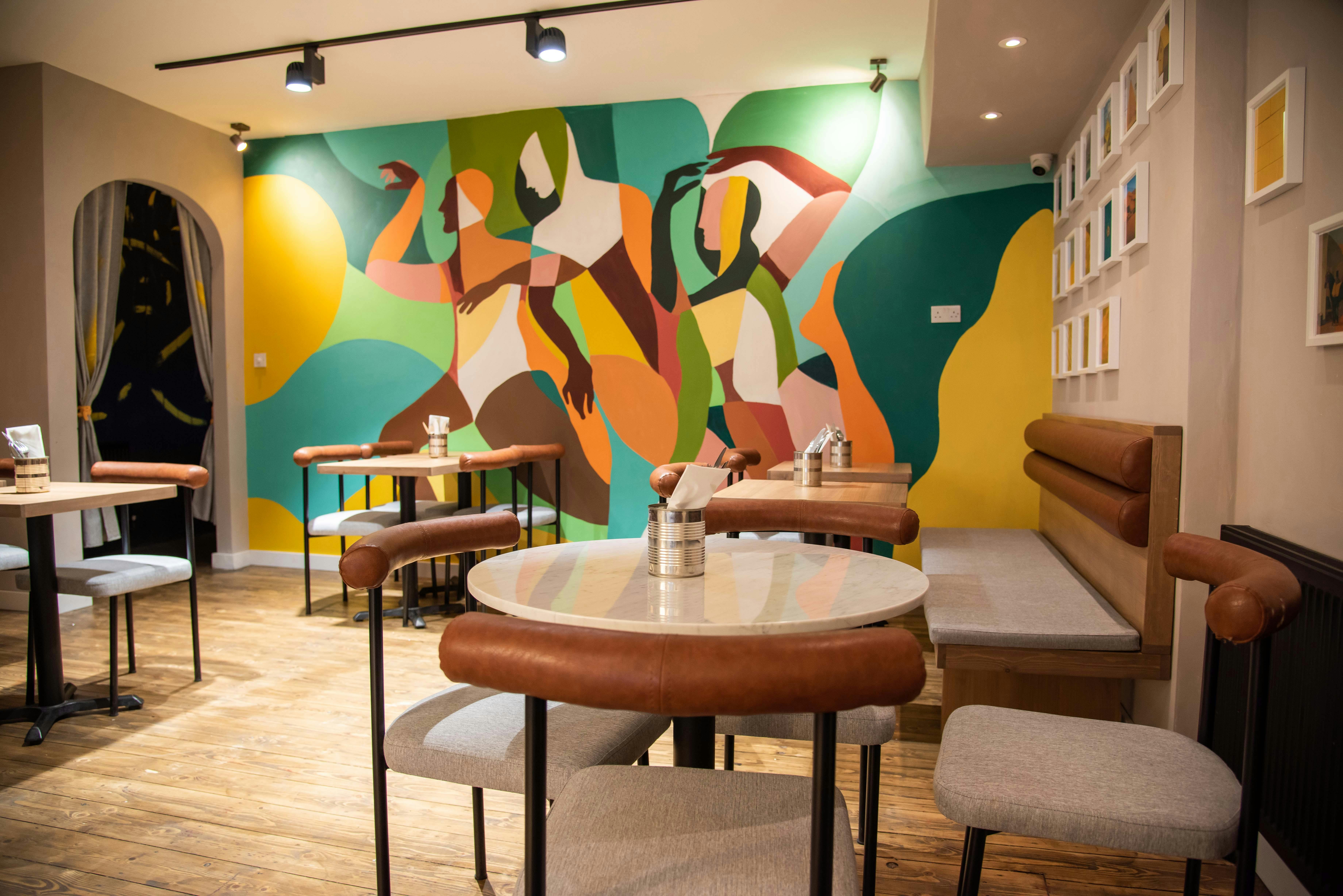 Vibrant event space with colorful mural for networking and casual gatherings.