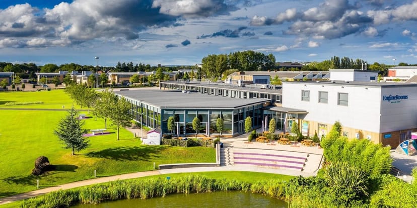 Modern event venue in Birchwood Park with lush greenery and serene water feature.