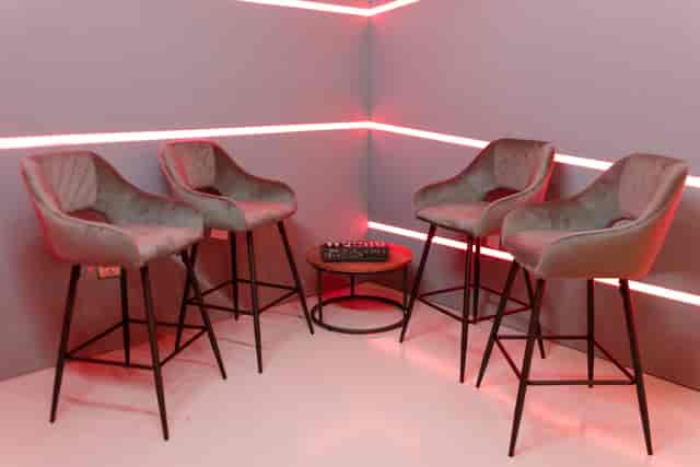 Stylish corner setup with modern bar stools for networking events and informal meetings.