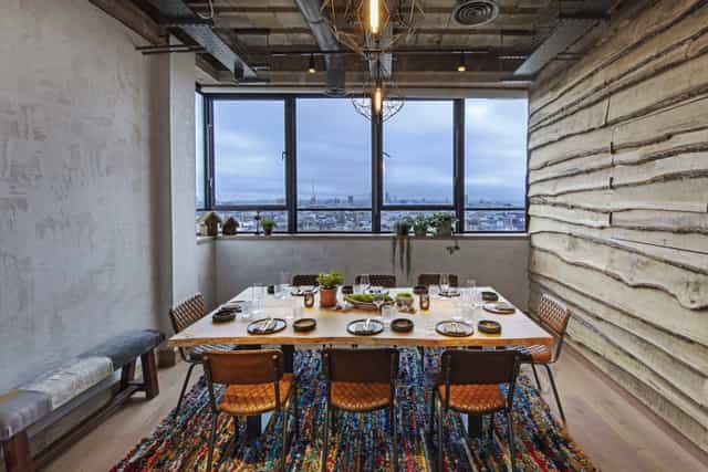 Stylish meeting space with wooden table at The Treehouse Hotel for corporate retreats.