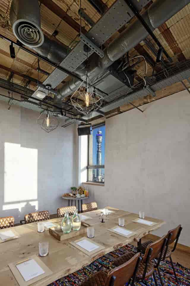 Modern meeting space at The Treehouse Hotel with industrial design and panoramic views.