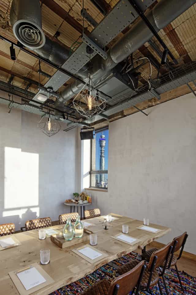 Modern meeting space at The Treehouse Hotel with industrial design and panoramic views.