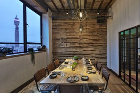 Stylish meeting space with wooden table at The Treehouse Hotel, perfect for corporate events.