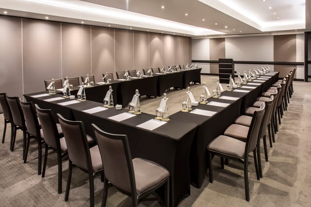 Optima Ballroom meeting room setup with U-shaped tables for professional events.