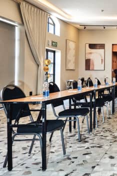 Modern meeting setup at Hyatt House Sandton with long table and black chairs.