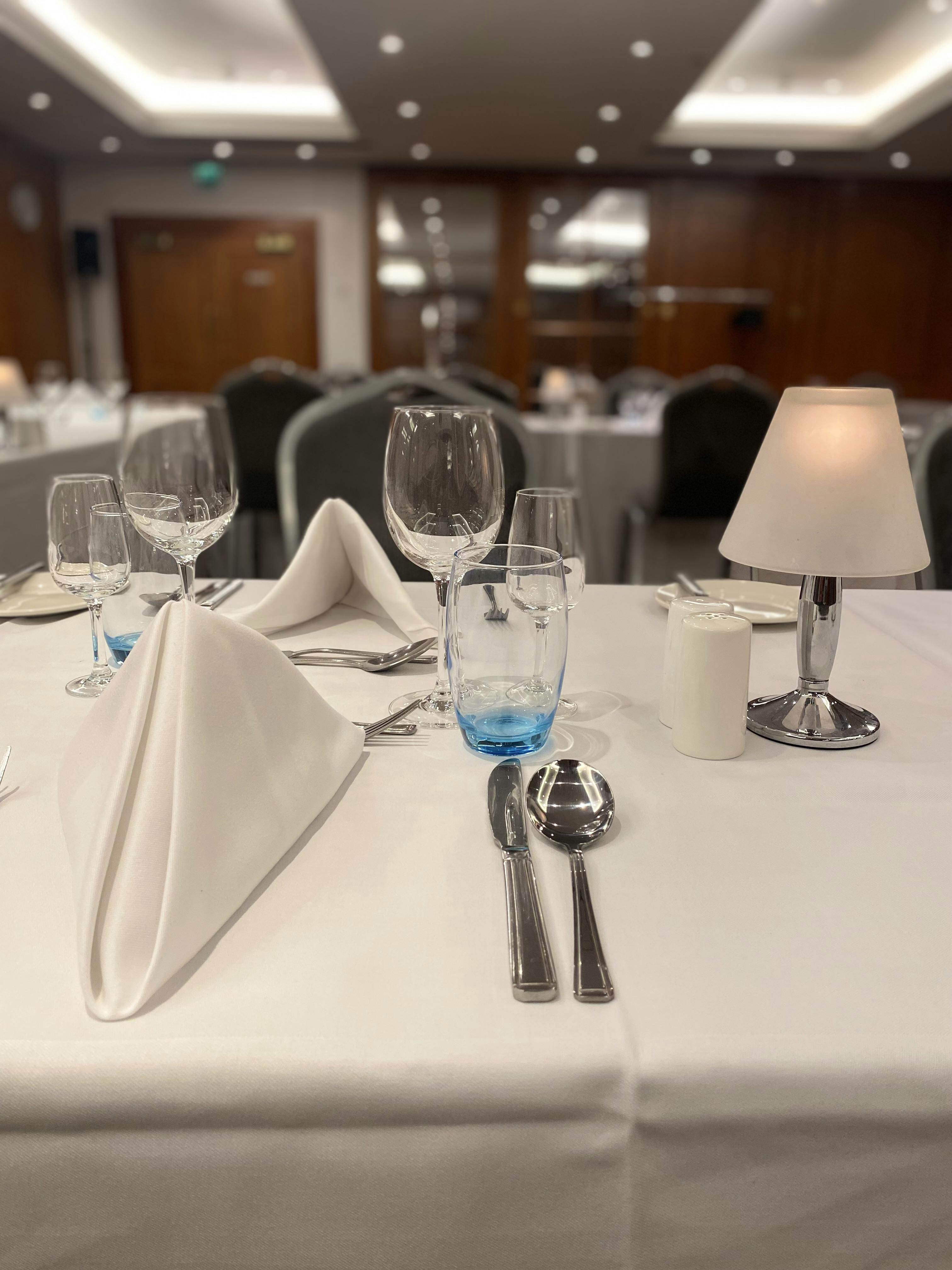 Elegant dining table setup in Prosper Suite, Ambassadors Bloomsbury Hotel for corporate events.