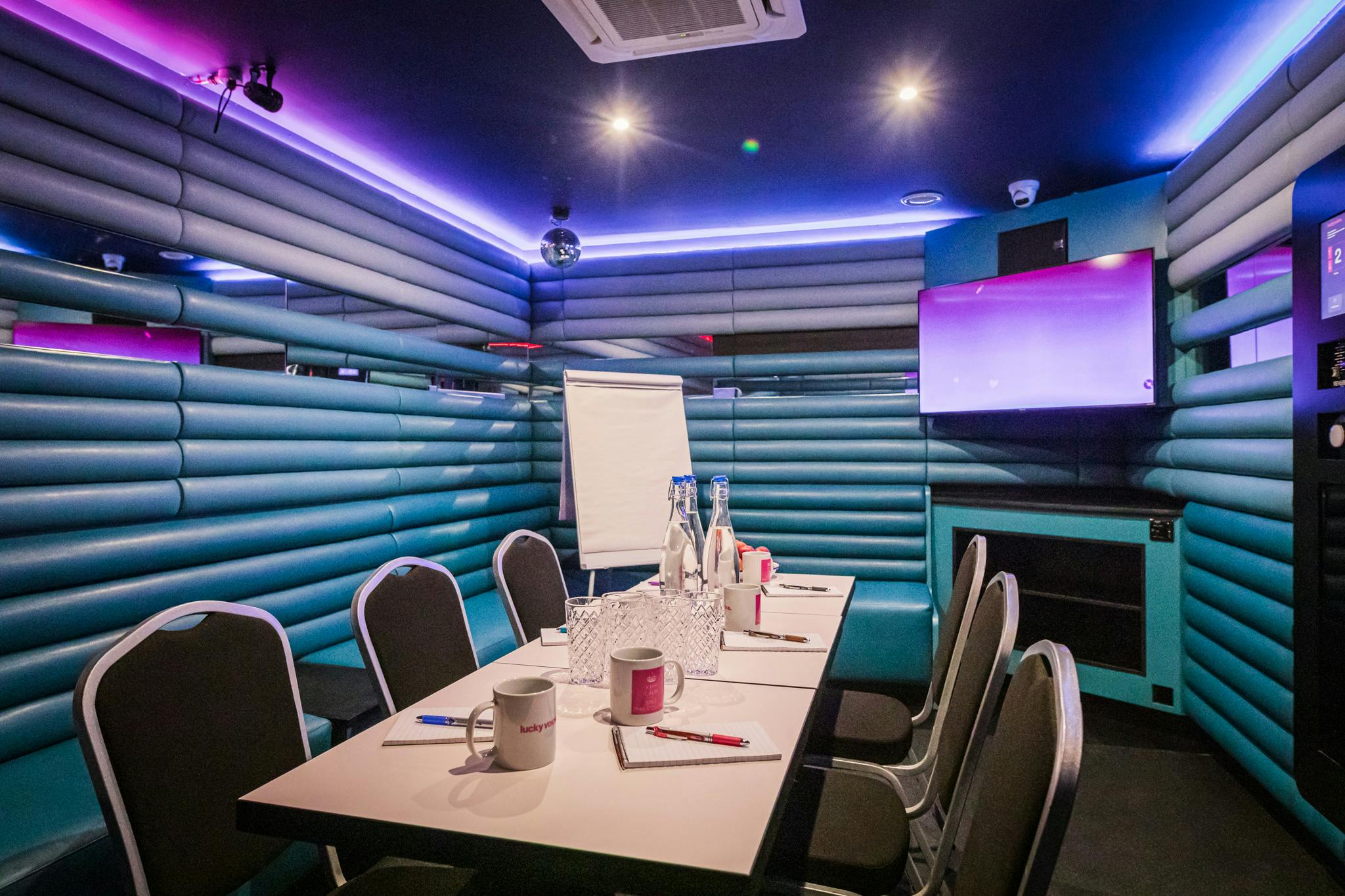 Private karaoke room with vibrant walls, ideal for creative meetings and workshops.