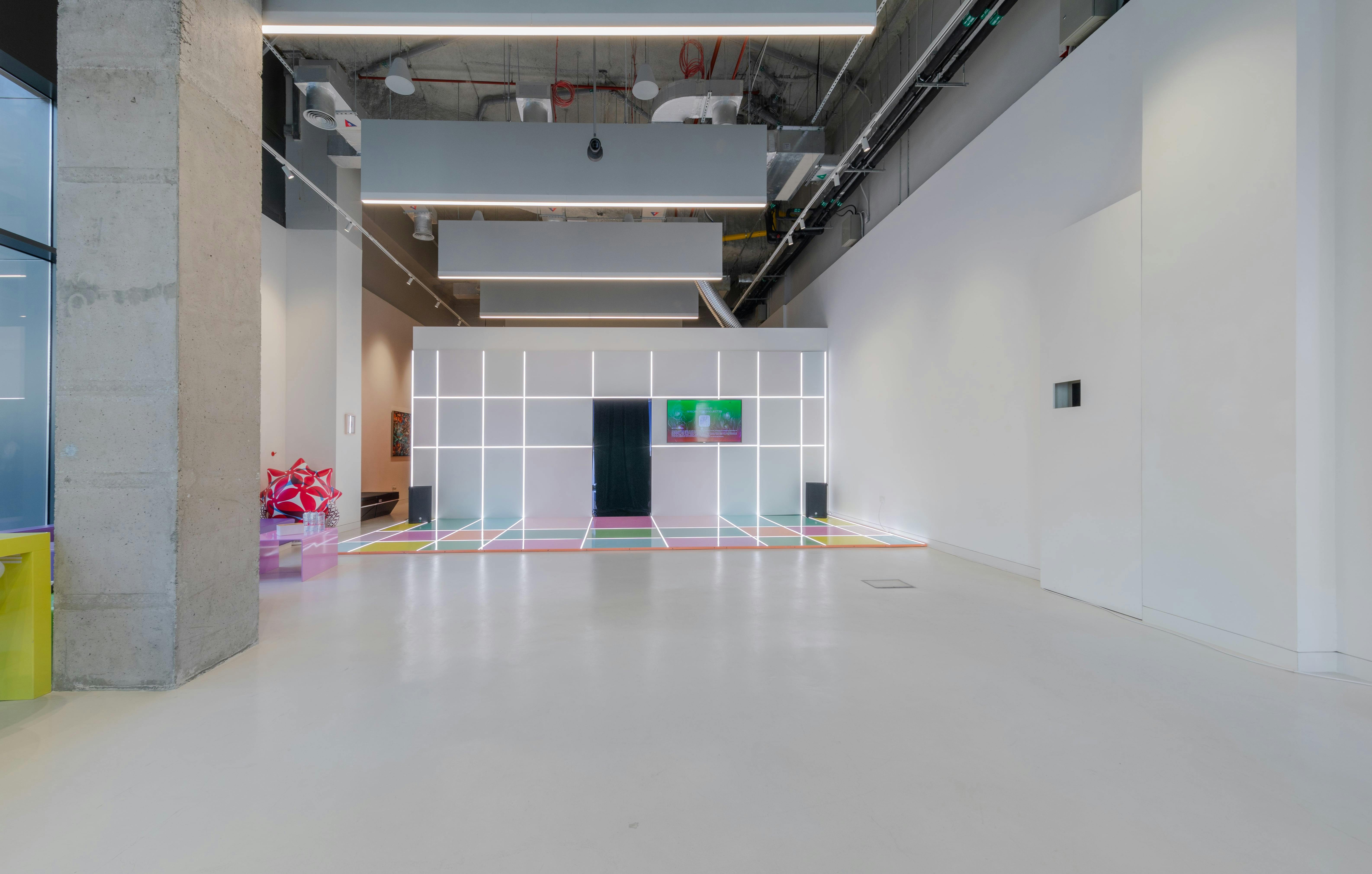 Modern event space with illuminated grid, perfect for tech launches and art exhibitions.