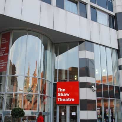 Modern Shaw Theatre exterior with large glass windows for events and conferences.