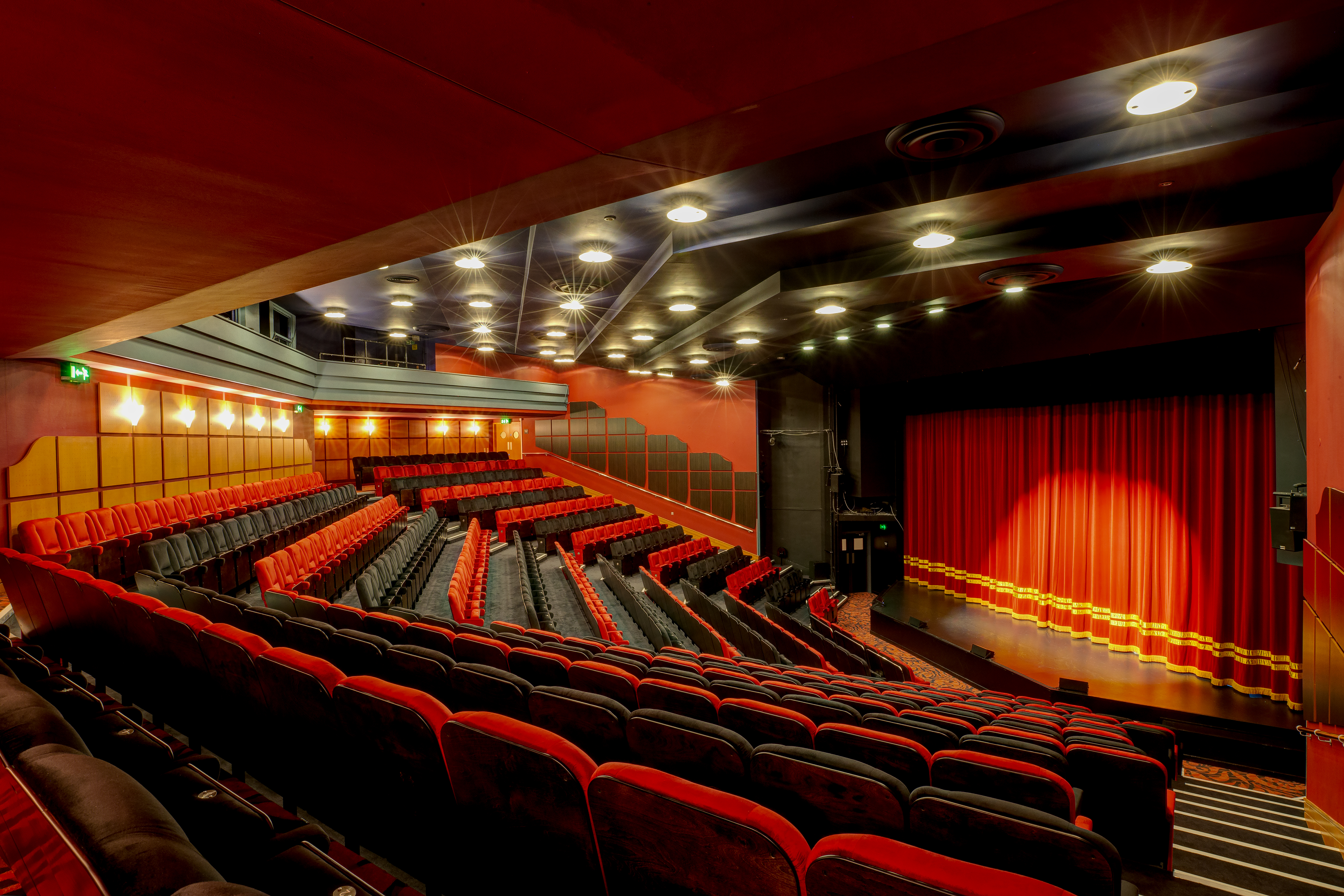 The Shaw Theatre with tiered seating, ideal for conferences and performances. - Banner
