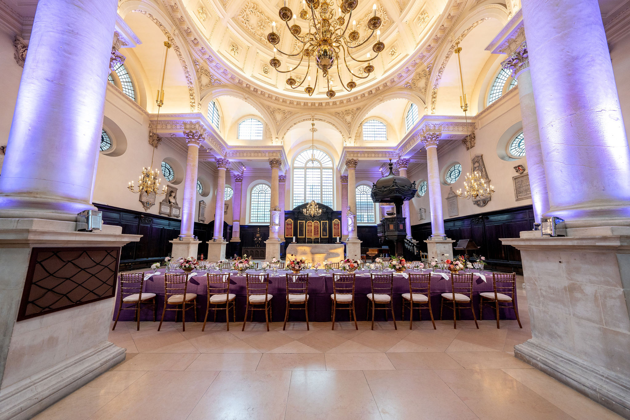 Elegant event space at St Stephen Walbrook with high ceilings and purple lighting. - Banner